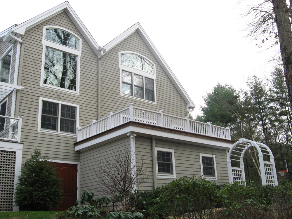 back view with garage, deck and custom windows