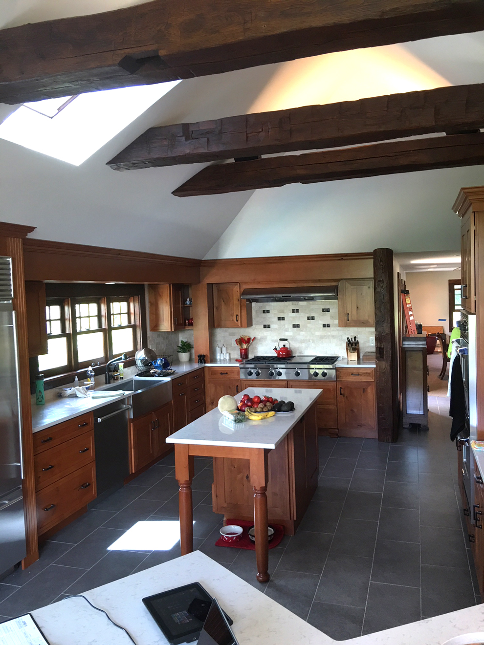 kitchen with furniture like island, interesting tiles and grey floor